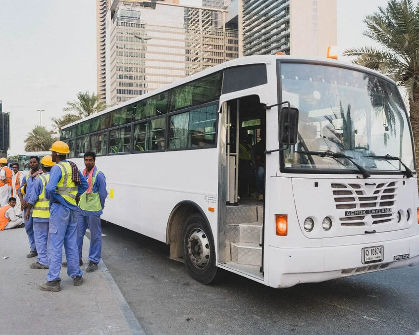 Crompton International workers boarding company transport for site mobilisation in Doha