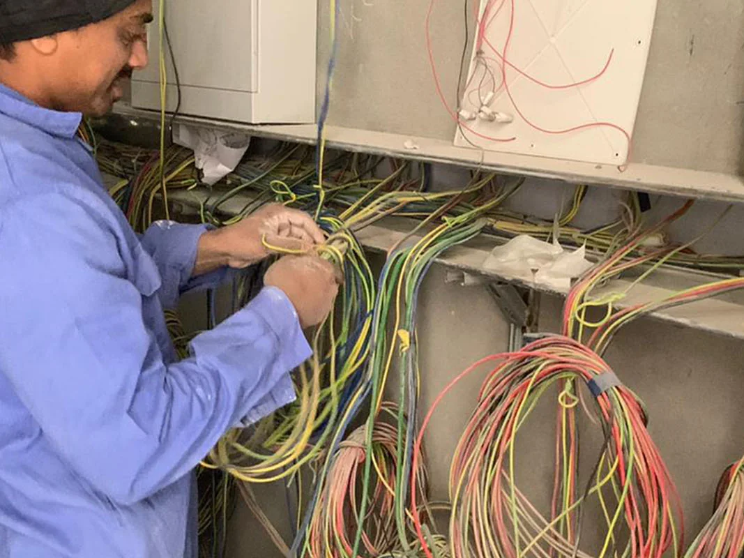 Electrician terminating wiring in a distribution board