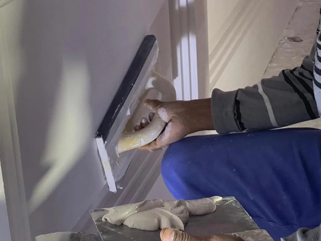 Plasterer finishing an internal wall